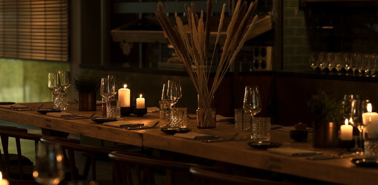 Set community table in the KITCHENS restaurant in the evening