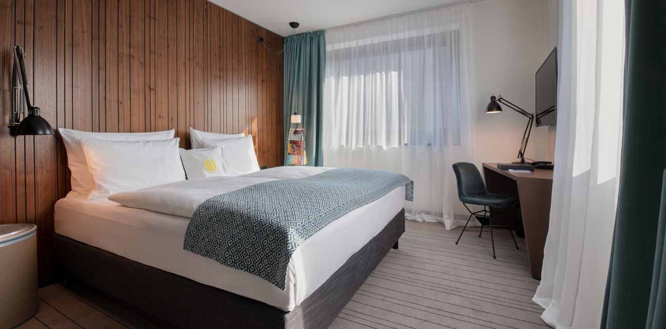 MEDIUM room bed and desk with window in background